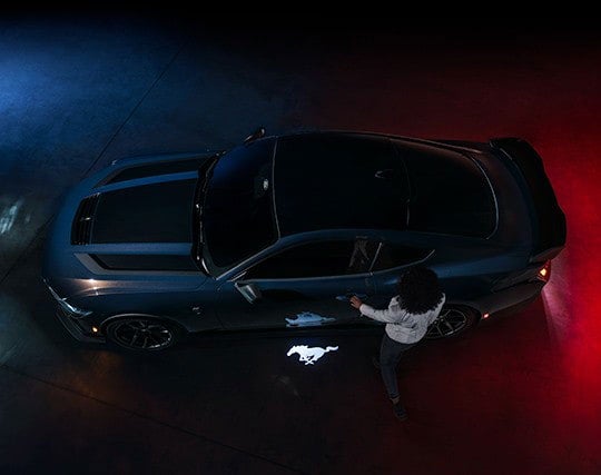 2024 Ford Mustang® Dark Horse™ model with a driver approaching the vehicle | Santee Ford in Manning SC