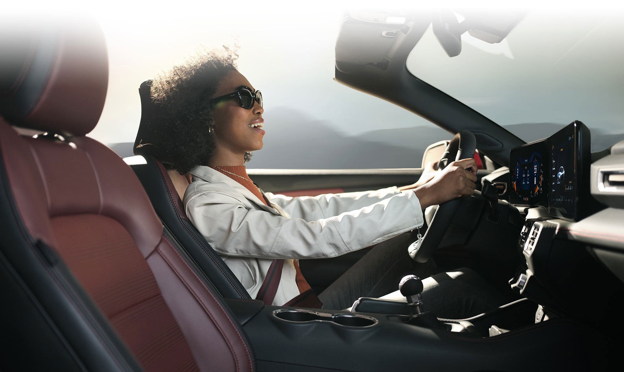 Person sitting in the driver’s seat of a 2024 Ford Mustang® convertible | Santee Ford in Manning SC