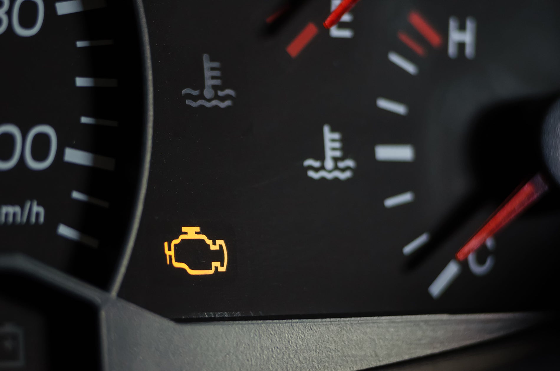 Illuminated check engine light on a vehicle instrument cluster