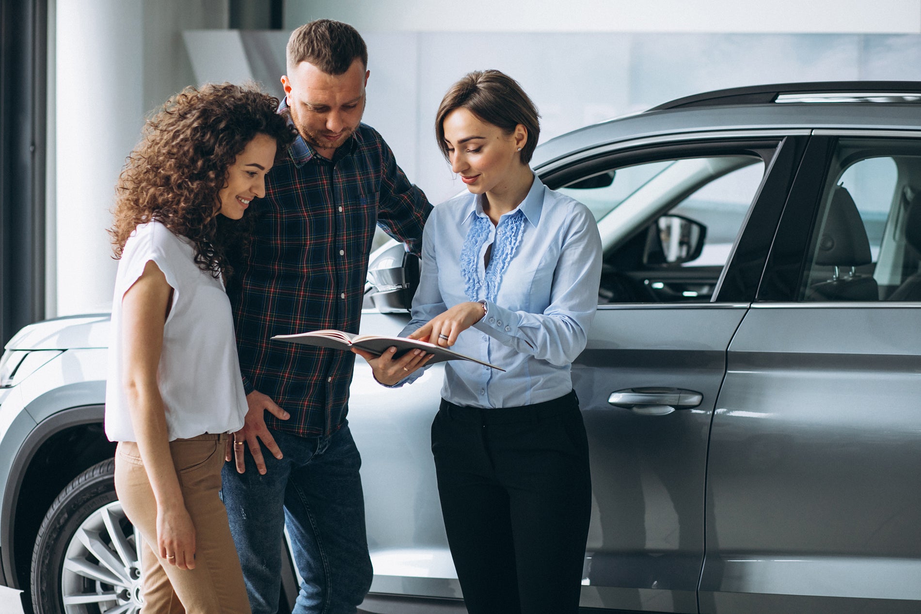 Couple reviewing Ford financing options with a sales consultant at Santee Ford